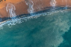 Aerial topdown view of wave patterns at Ringstead Bay, Dorset, UK.