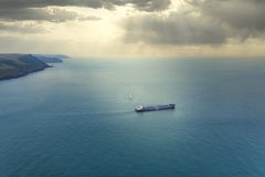 Aerail view of cargo ship and yacht, Fowey, Cornwall, UK.