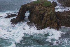 Aerial view of Enys Dodnan Arch, Lands End, Cornwall, UK